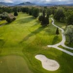 A golf course with many trees and a path